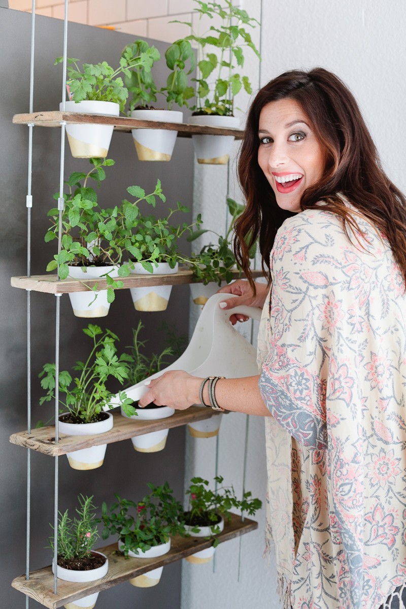 Make this Custom Potted Hanging Herb Garden. An easy DIY for your home made from pallet wood and inexpensive terra cotta pots! - Click through for the full tutorial. - Hanging Herb Garden DIY by popular Florida lifestyle blogger Fresh Mommy Blog