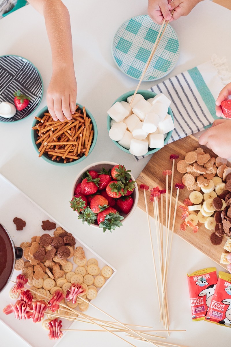 Kid Friendly Fondue Party - Just two simple ingredients gives you deliciously smooth chocolate fondue for your next party or after school snack and serve with your favorite snacks for a kid friendly fondue (fountain not required, but it is totally fun right?!)