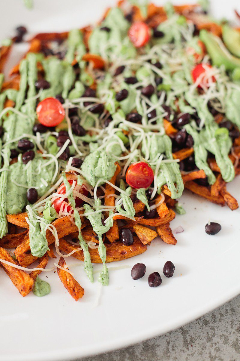 Loaded Sweet Potato Mexican Street Fries with Avocado Lime Dressing! A skinny and delicious twist on a loaded fry platter that won't mess with your waistline or derail your resolutions! Need a dinner to drool over? Try these Loaded Sweet Potato Mexican Street Fries! A skinny and delicious twist on a loaded fry platter that won't mess with your waistline or derail your resolutions! A healthy and hearty recipe from Tabitha Blue of Fresh Mommy Blog with Horizon.