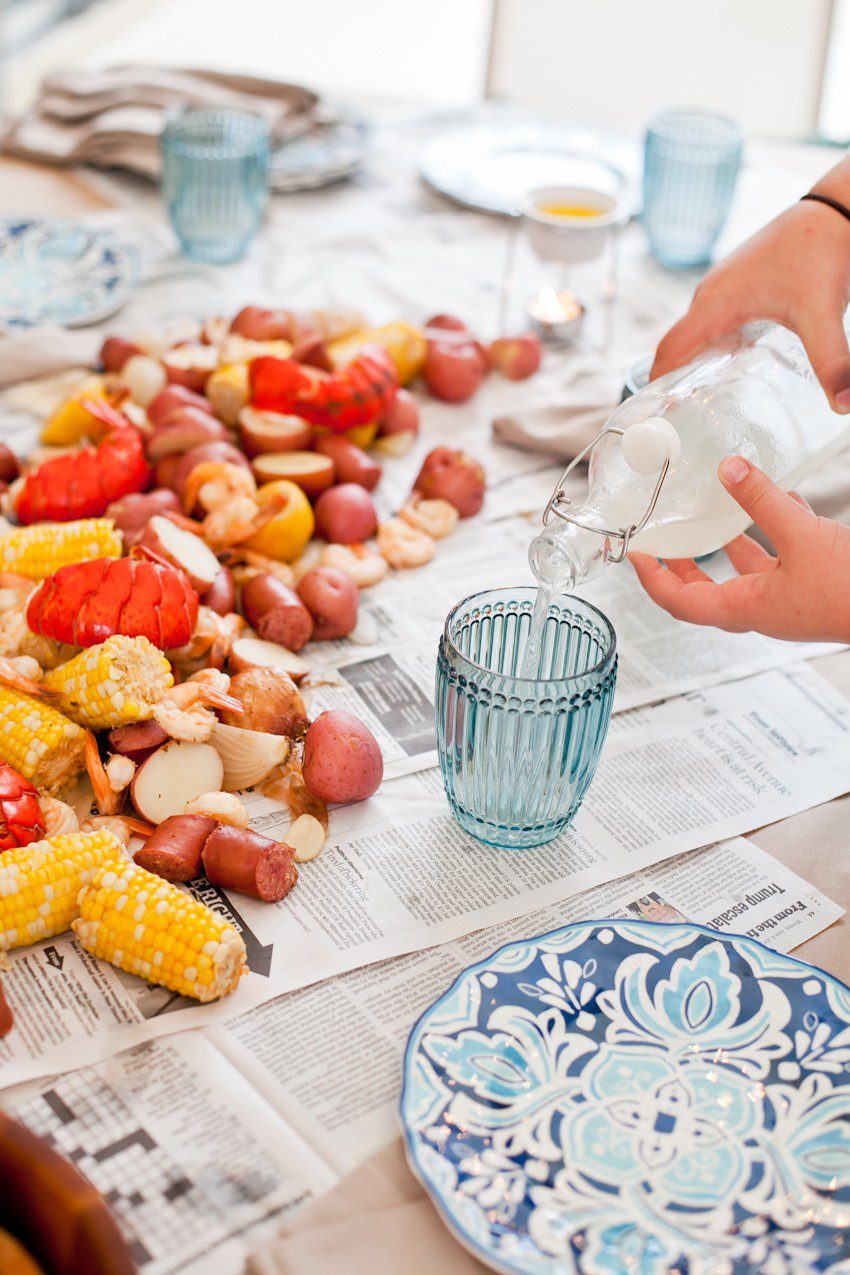 How to host a seafood boil for easy summer entertaining! Think a seafood boil seems like a lot of effort to pull off? We did too... until our first one! Read on for our simple tips to create your own summer seafood affair.