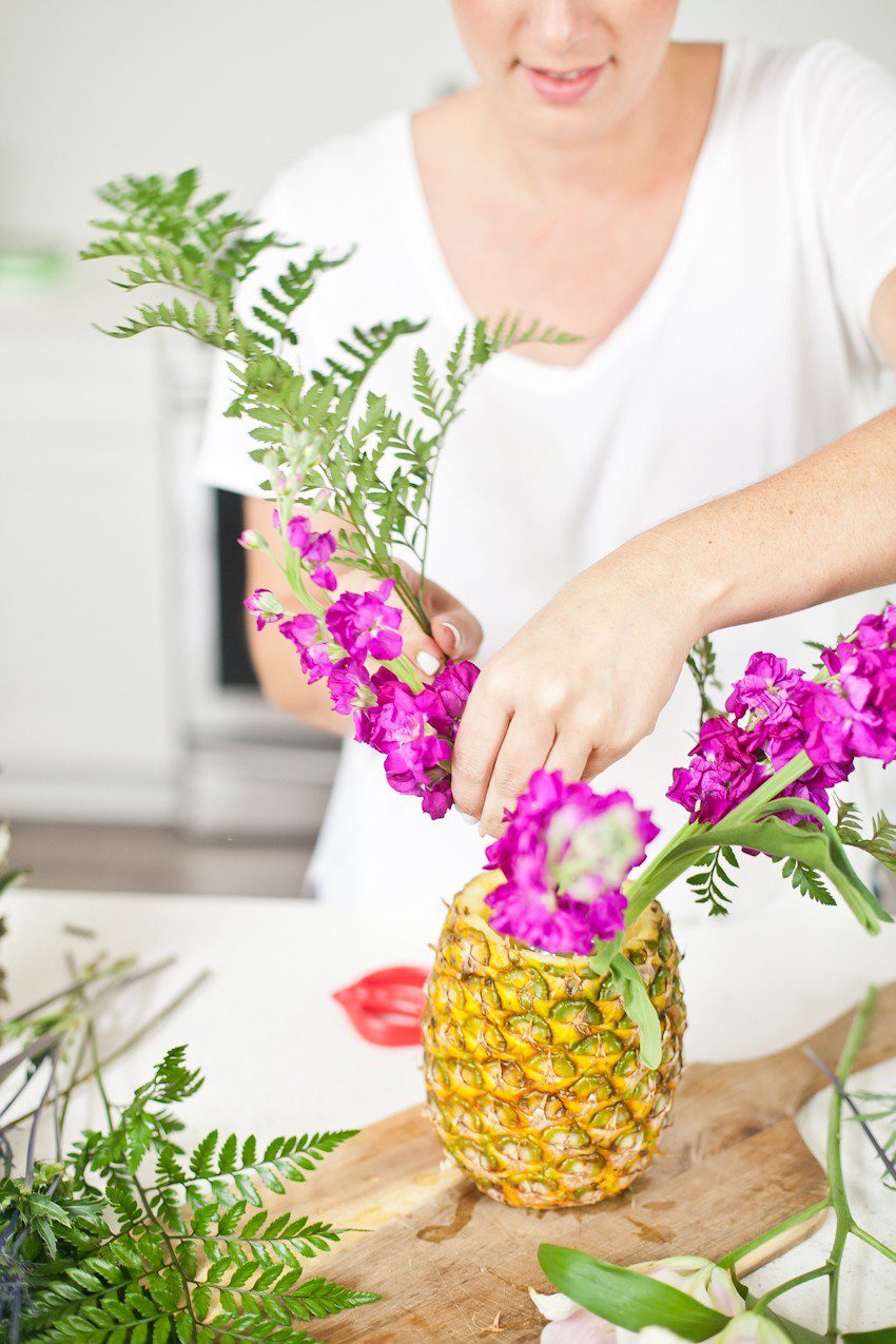 Pineapple Flower Arrangement for garden parties or a summer tropical fete! This DIY Pineapple vase is an easy to make centerpiece or perfect for a Tiki bar! - Tropical Pineapple Floral Arrangement featured by popular Florida lifestyle blogger Fresh Mommy Blog