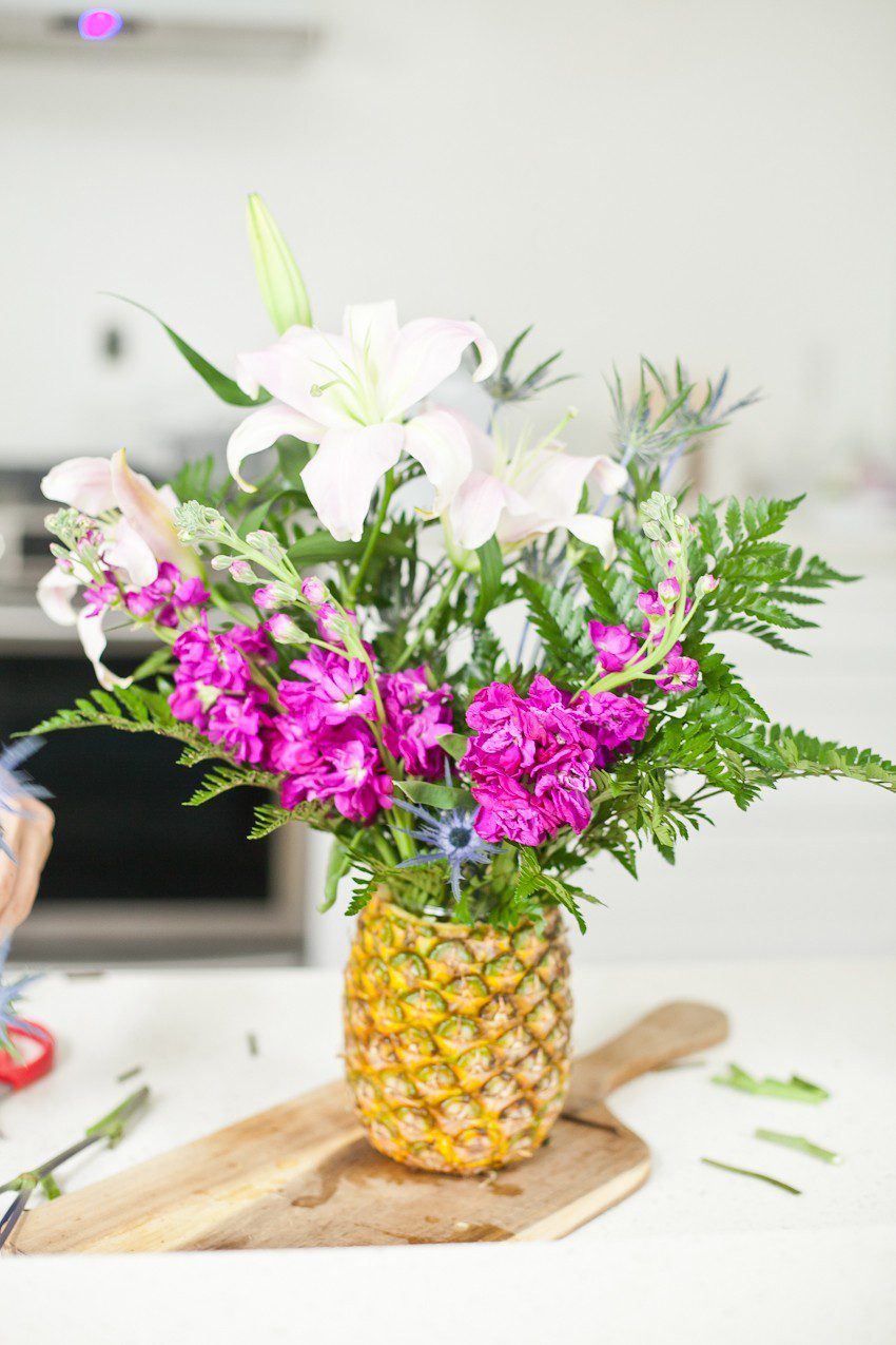 Pineapple Flower Arrangement for garden parties or a summer tropical fete! This DIY Pineapple vase is an easy to make centerpiece or perfect for a Tiki bar! - Tropical Pineapple Floral Arrangement featured by popular Florida lifestyle blogger Fresh Mommy Blog