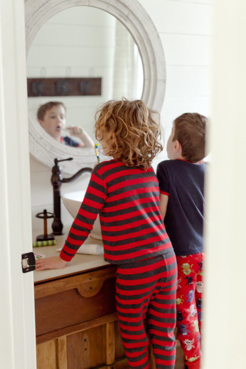 Our Family Morning Routine: A Behind the Scenes look at a what a REAL morning looks like for a busy family. Best daily morning routine ideas for kids and before school. | How to Get Ready for School: 5 Sensational Strategies to Make Easy on your Family by popular Tampa life and style blog, Fresh Mommy: image of two young boys brushing their teeth.