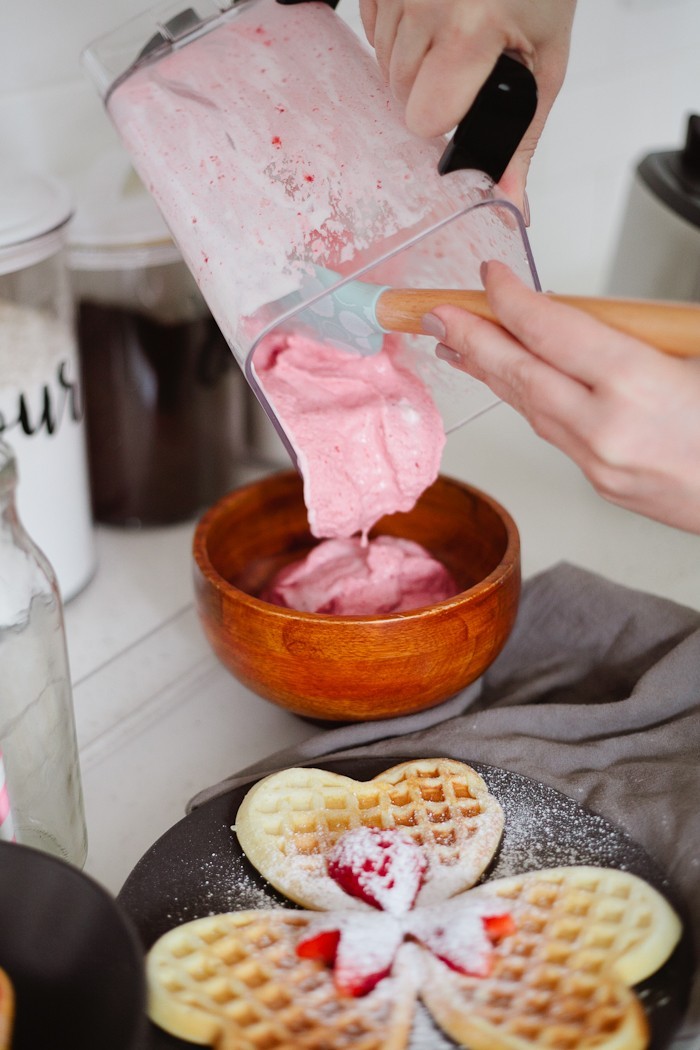 Valentine's Day Breakfast in Bed full of all things sweet, pink and delicious, of course! Heart waffles and strawberries and cream smoothie bowl, that tastes like ice cream, and heart shaped strawberries steal the show in this morning breakfast tray styled for your valentine.