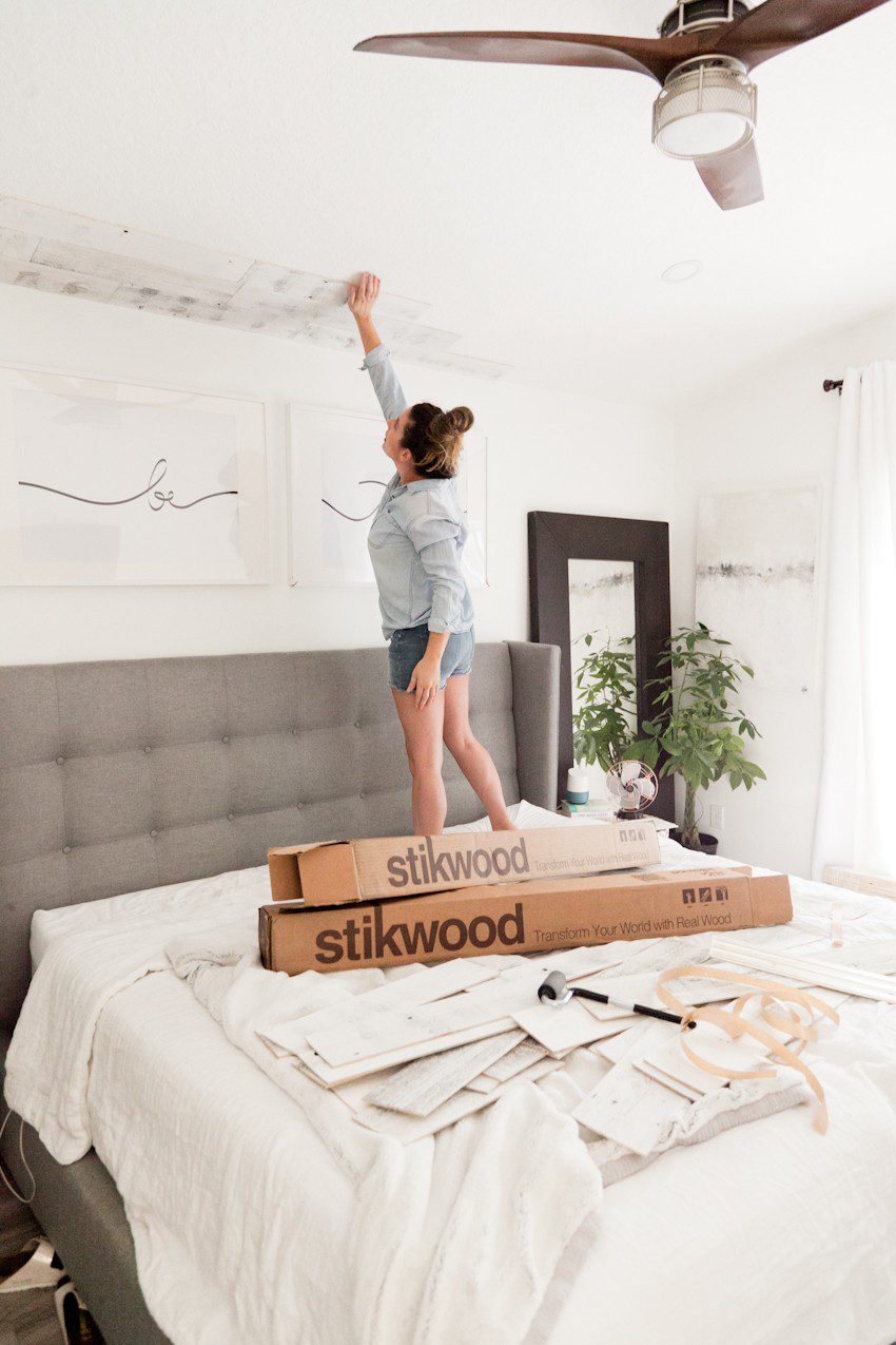 How to Install your Own Reclaimed Wood Ceiling - Master Bedroom Update featured by top Florida lifestyle blog, Fresh Mommy Blog: woman installing reclaimed wood ceiling in her master bedroom