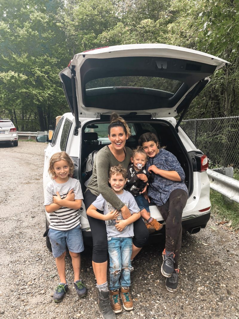 Kitten Care Tips: 5 Essentials you Need to Raise a Cat by popular lifestyel blogger Tabitha Blue of Fresh Mommy Blog: image of mom and 4  young kids sitting in the back of a car and holding a black kitten.