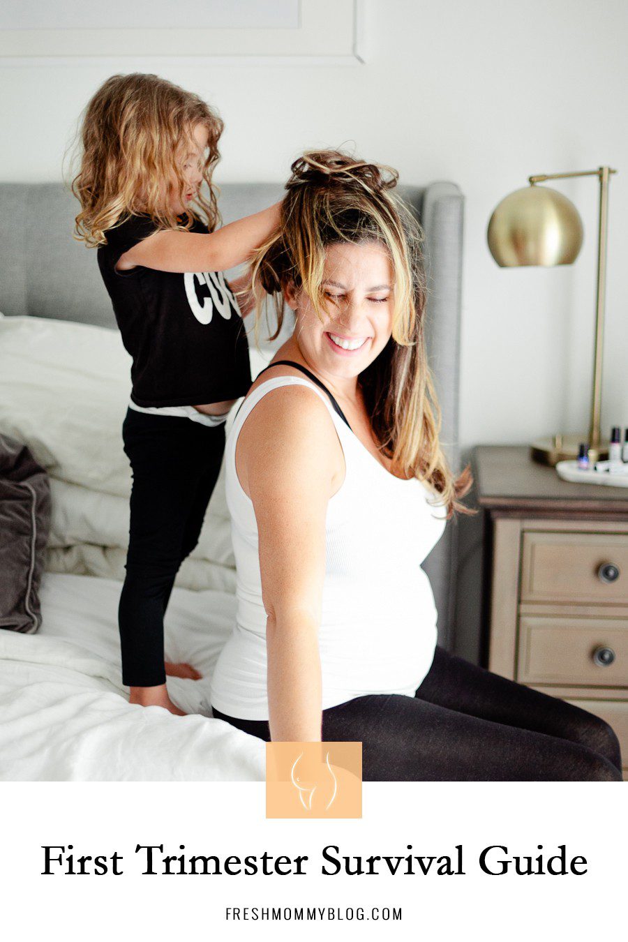 My First Trimester Survival Guide: Tips and Favorites | First Trimester Pregnancy Essentials: An Early Pregnancy Survival Guide by popular Florida lifestyle blog, Fresh Mommy Blog: Pinterest graphic of a mom sitting on her bed while her young daughter stand behind her and plays with her hair.