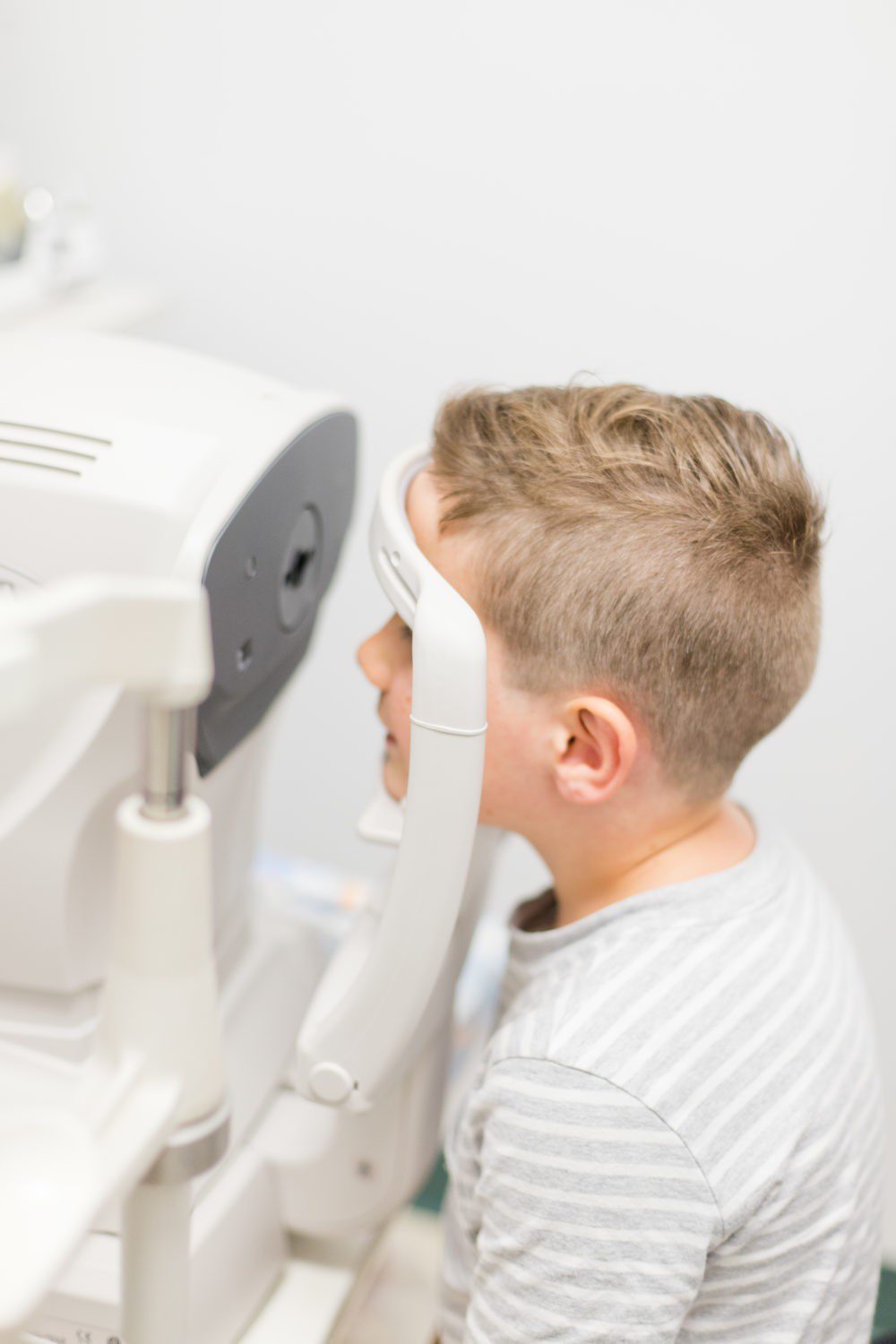Back to School Eye Exam: How to Prepare your Child for a Successful Academic Year | Back to School Eye Exam: How to Prepare your Child for a Successful Academic Year by popular Florida lifestyle blog, Fresh Mommy Blog: image of a young boy getting his eyes examined.