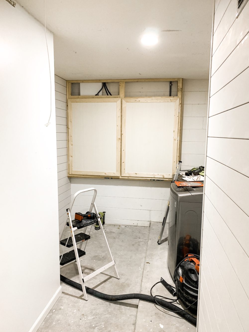 DIY for Covering Breaker Boxes: A Faux Cabinet Tutorial | How We Designed a Family Friendly Laundry Room in our Garage - The Reveal! by popular Florida DIY blog, Fresh Mommy: image of a family friendly laundry room.