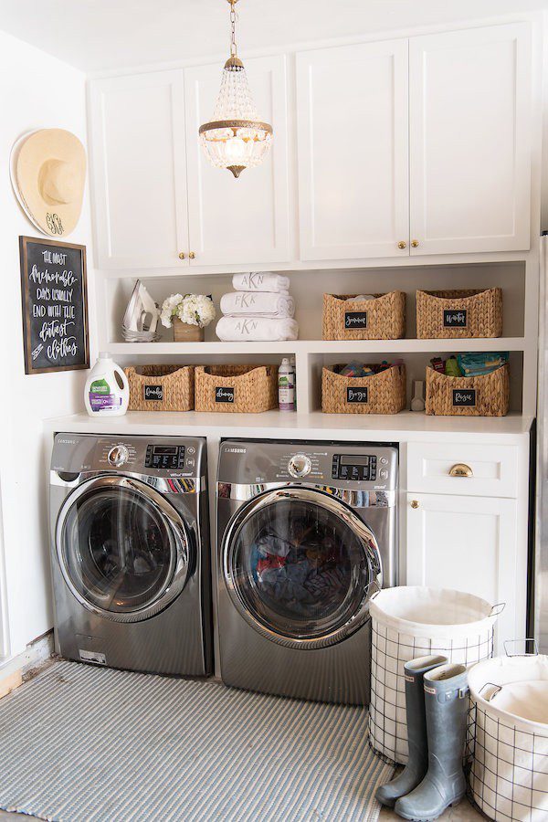 Laundry Room Makeover Ideas! Design plans and ideas for creating a family friendly laundry room. | Contemporary Laundry Room Ideas: A Light + Modern Design Plan by popular Florida lifestyle blog, Fresh Mommy: image of a remodeled laundry room with wire laundry baskets, front loading washer and dryer, white cabinets,and woven storage baskets.