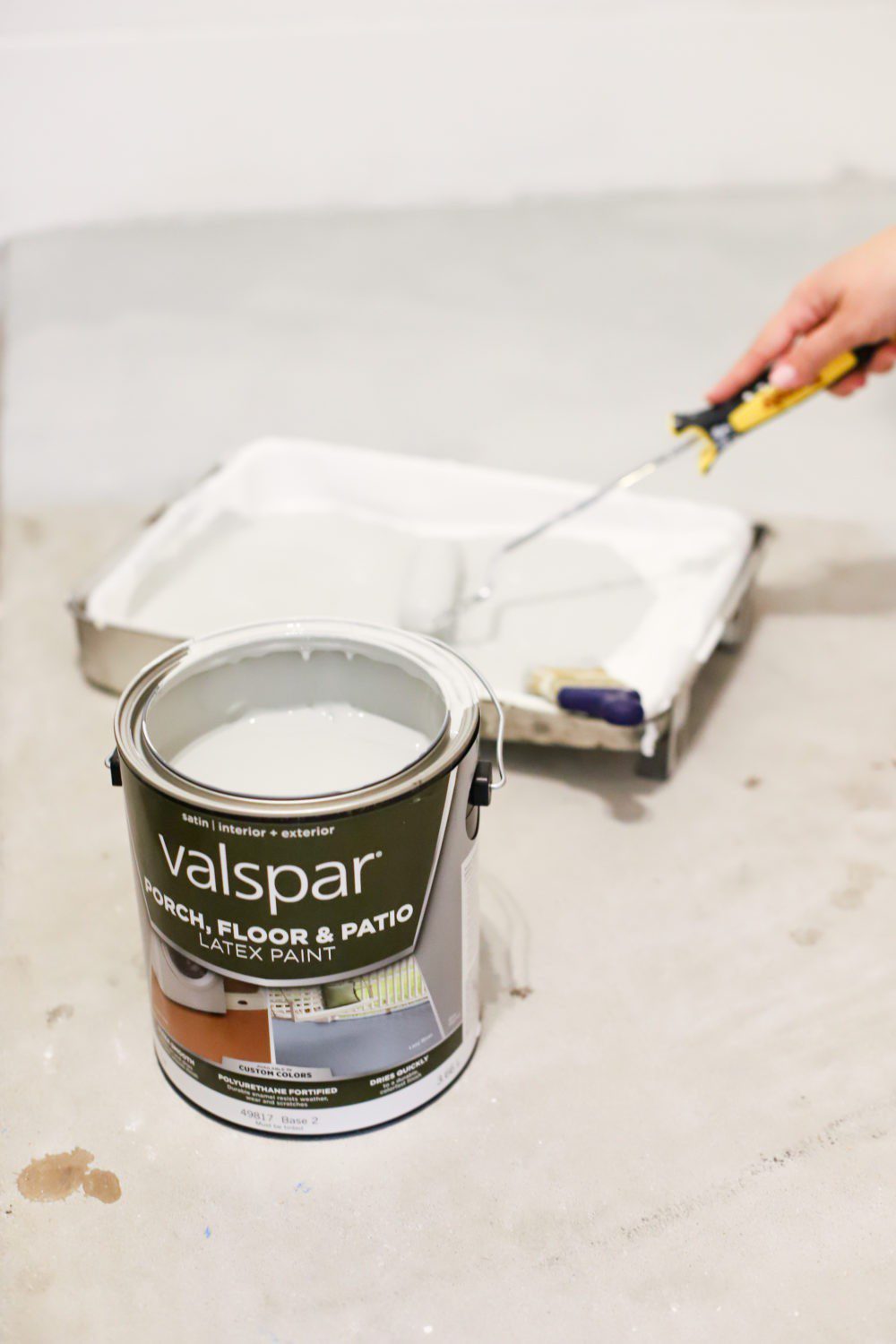 Laundry Room DIY: How to Paint a Cement Floor with Stencils | Laundry Room DIY: How to Paint a Cement Floor with Stencils by popular home decor blog, Fresh Mommy: image of Valspar porch and floor paint, paint pan, and paint roller.