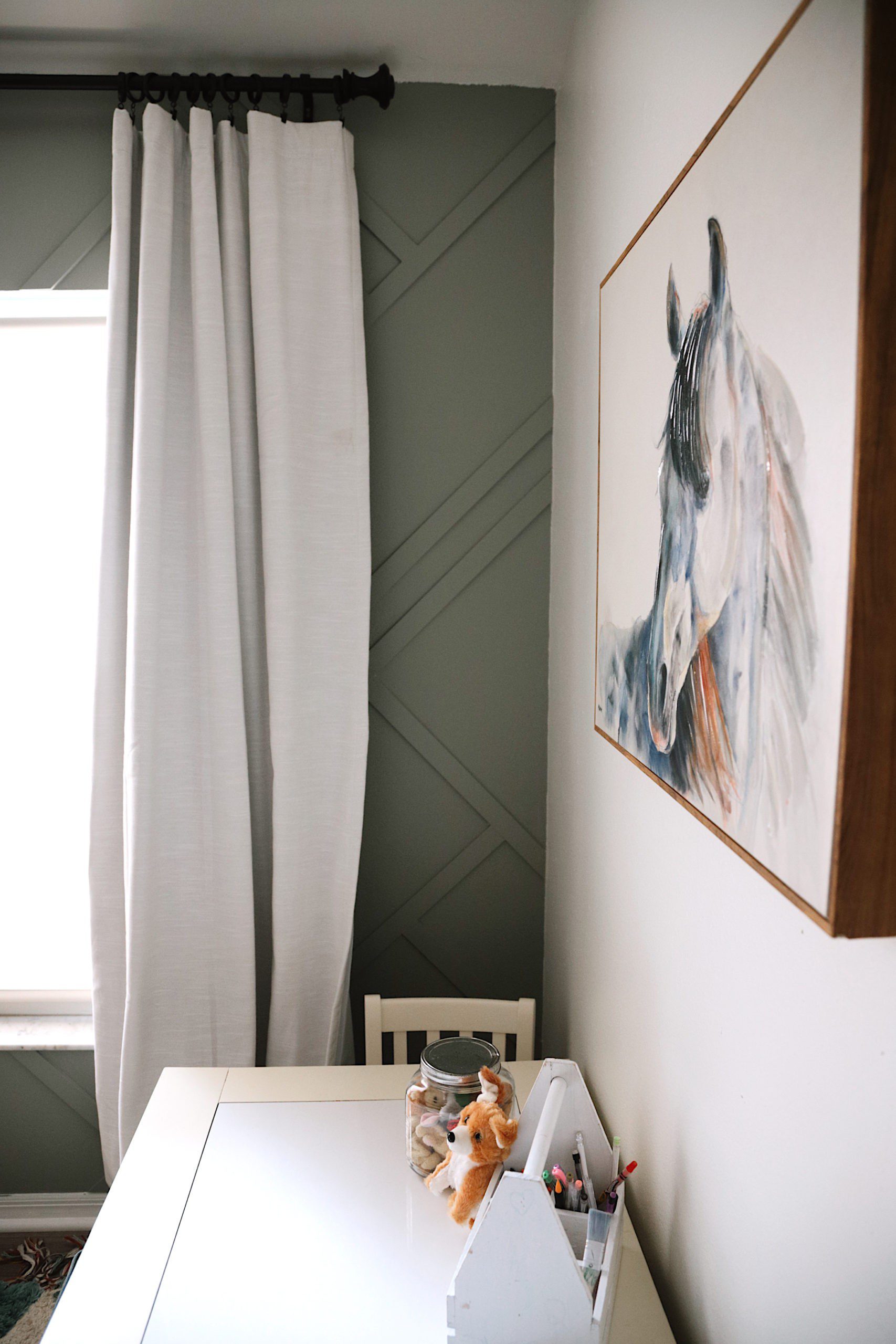 Shared girls' room design with DIY accent wall with one of Valspar's 12 new colors of the year for 2020, Secret Moss. For their 12 shades for 2020, Valspar sought to bring the tranquility of nature into a room to create naturally therapeutic, serene spaces. I love how this dusky moss green (with a hint towards gray) creates a calming escape in our girls' room. We went with one of Valspar's 12 new colors of the year for 2020, Secret Moss. For their 12 shades for 2020, Valspar sought to bring the tranquility of nature into a room to create naturally therapeutic, serene spaces. I love how this dusky moss green (with a hint towards gray) creates a calming escape in our girls' room. We went with one of Valspar's 12 new colors of the year for 2020, Secret Moss. For their 12 shades for 2020, Valspar sought to bring the tranquility of nature into a room to create naturally therapeutic, serene spaces. I love how this dusky moss green (with a hint towards gray) creates a calming escape in our girls' room. | Gorgeous Wood Feature Wall + Shared Girl's Room Update by popular Florida home decor blog, Fresh Mommy Blog: image of a shared girls' room decorated with a Lowe's South Shore Furniture Versa Gray Maple 6-Drawer Double Dresser, Lowe's LEVOLOR Trim+Go Shadow Light Filtering Cordless Solar Shade, Lowe's allen + roth 2-Pack Black Curtain Rod Finials, Lowe's Paint Paints & Primers Paint Samples Item # 1185292 Model # 5005-2A Valspar Secret Moss Interior Paint, Lowe's DAP DryDex 8-oz White Spackling, Lowe's allen + roth Matte Black 72-in To 144-in Matte Black Steel Single Curtain Rod, and Lowe's allen + roth LL WARWICK 42-IN x 84-IN TAUP PNL 84-in Taupe Polyester Blackout Thermal Lined Single Curtain Panel.