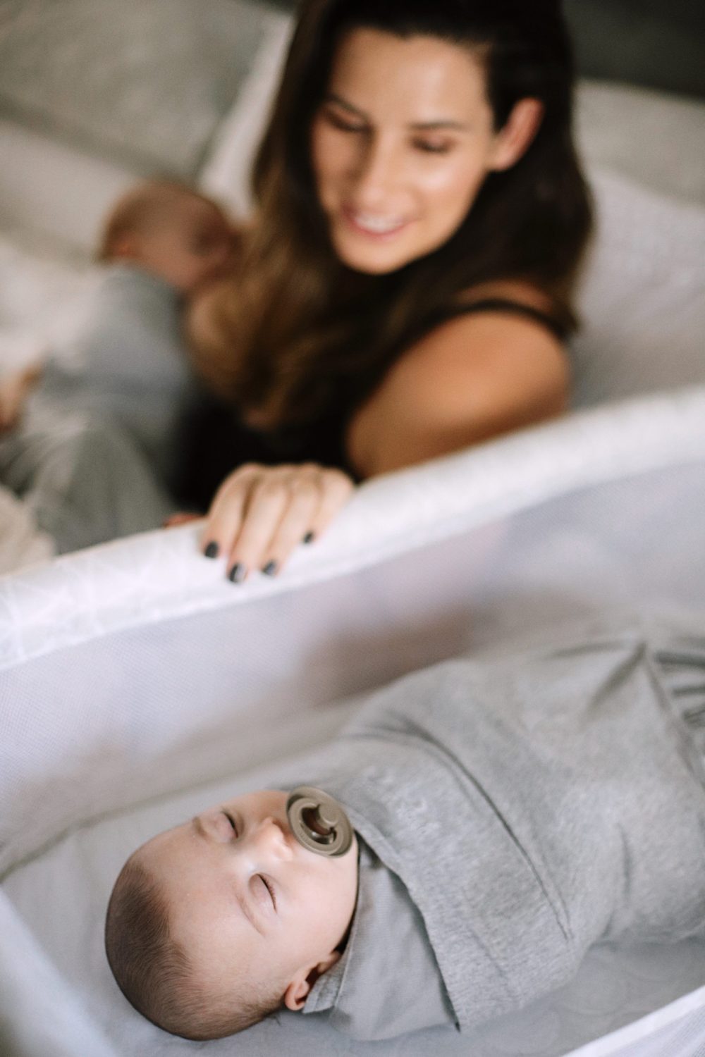 5 Breastfeeding Tips and Lactation Smoothie Recipe | Lactation Smoothie Recipe by popular Florida mommy blog, Fresh Mommy Blog: image of a woman nursing one her twin babies and looking over at her other twin baby that is sleeping in a bassinet. 