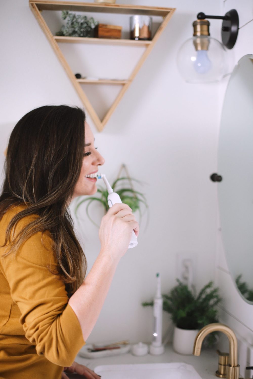 5 Things to Stop in 2020! Let's not hijacking our future by doing these 5 things in the present. It's time for a full, productive, successful year! | 5 Things to Stop Doing in 2020 + Quotes to Inspire Your Year by popular Florida life and style blog: image of a woman brushing her teeth.