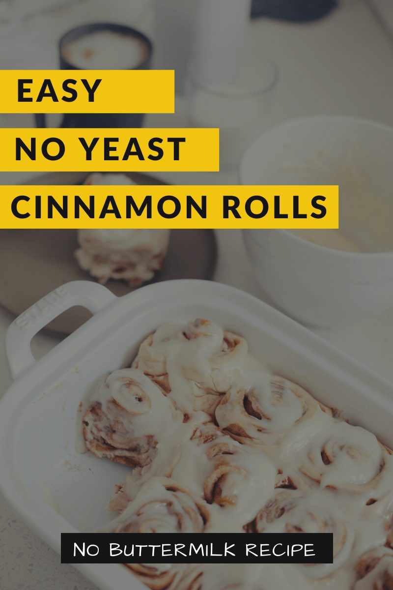 Quick and easy no yeast cinnamon rolls dough. Tips for no buttermilk and buttermilk substitute. NO waiting overnight. Click for the recipe and videos of yeast free cinnamon rolls homemade. Best yeast free cinnamon buns! Rolled with rich and gooey filling, clone of a Cinnabon cream cheese icing, and made without yeast, Homemade Cinnamon Rolls are ready to enjoy in under an hour. | Bread Machine Cinnamon Roll Recipe by popular Florida lifestyle blog, Fresh Mommy Blog: Pinterest image of cinnamon rolls in a white ceramic baking dish next to a bowl of cream cheese icing. 