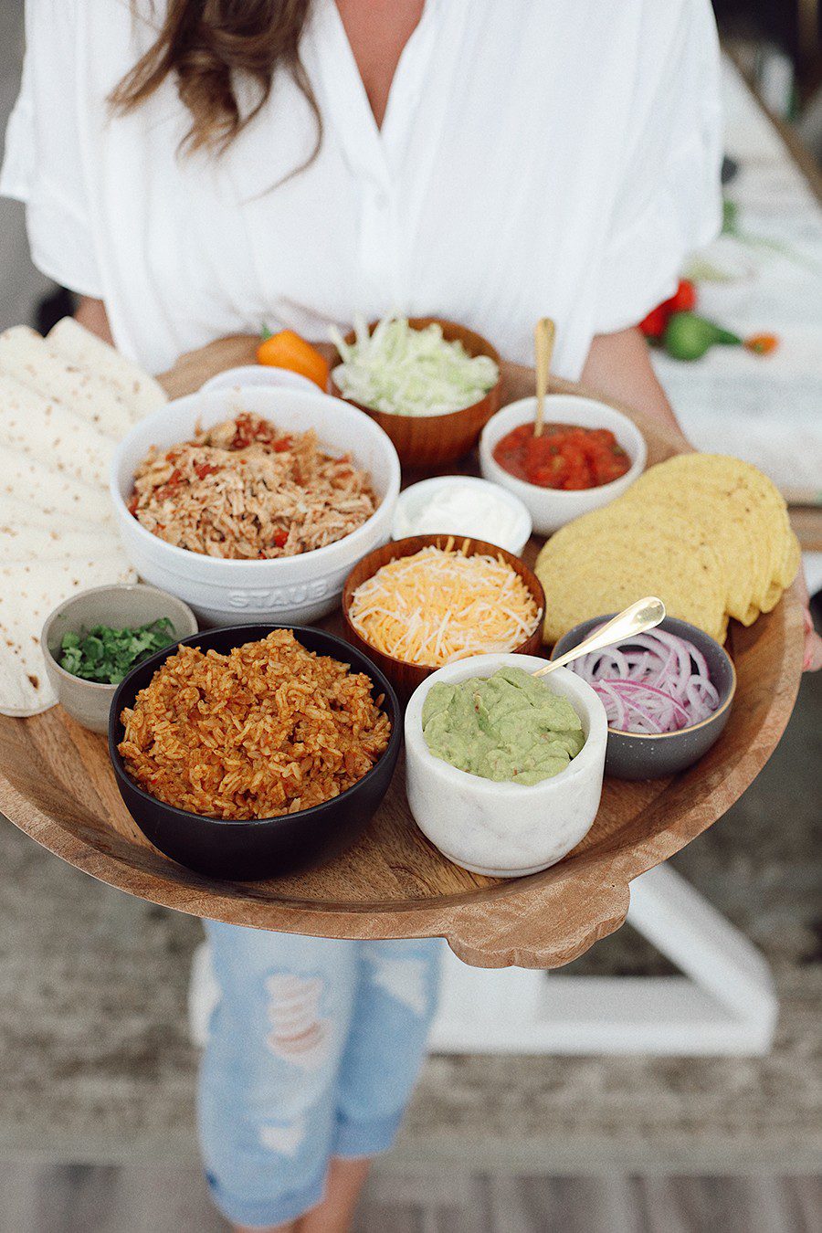 Slow Cooker Chicken Taco Board | Chicken Tacos by popular Florida lifestyle blog, Fresh Mommy Blog: image of Tabitha Blue holding a Chicken Tacos platter. 