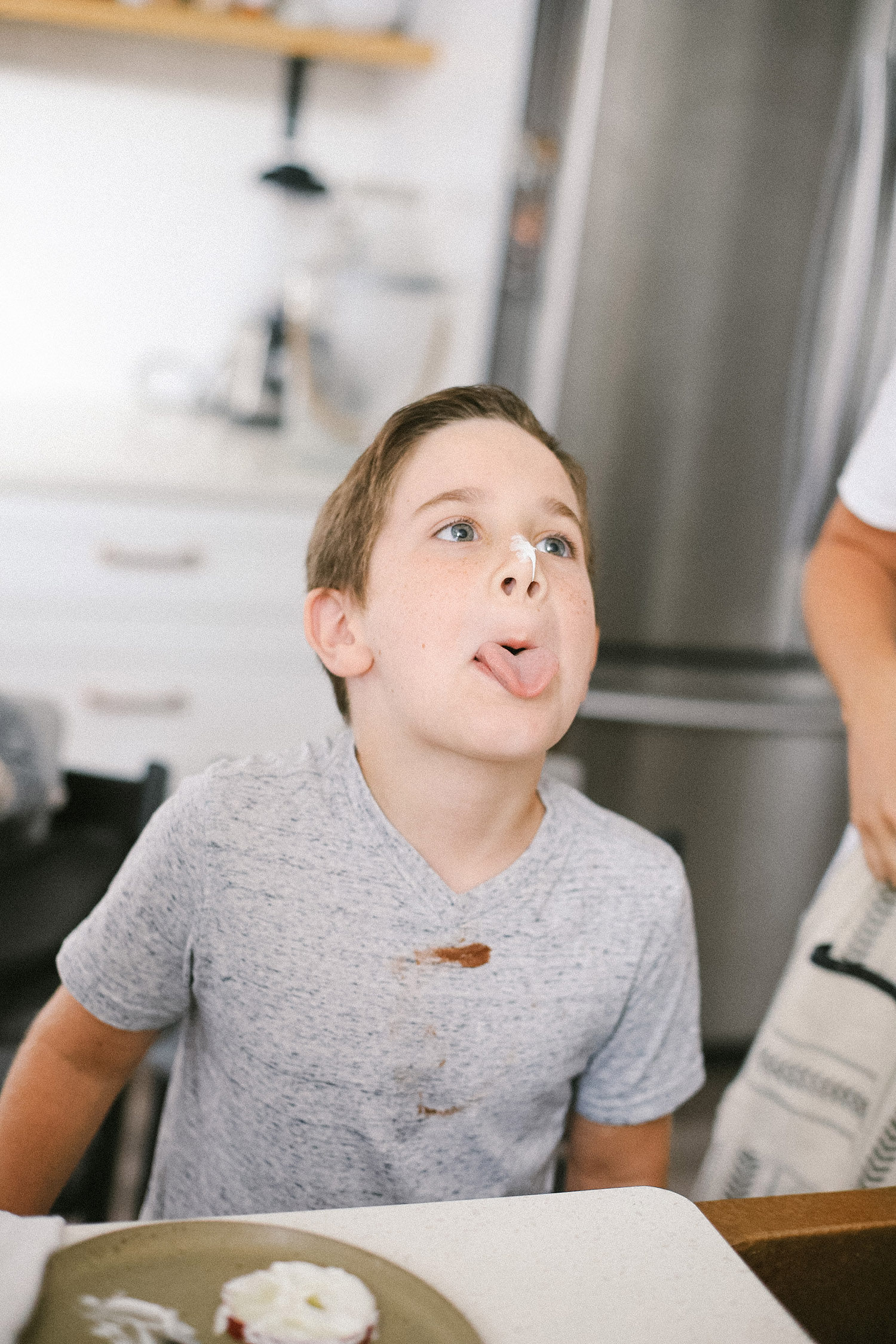 Easy snack ideas for a healthy sweet snacktivity for kids! Apple Donut fun recipe for kids from top Florida blogger Tabitha Blue of Fresh Mommy Blog | Apple Donuts by popular Florida motherhood blog, Fresh Mommy Blog: image of little boy with marshmallow fluff on his nose.  
