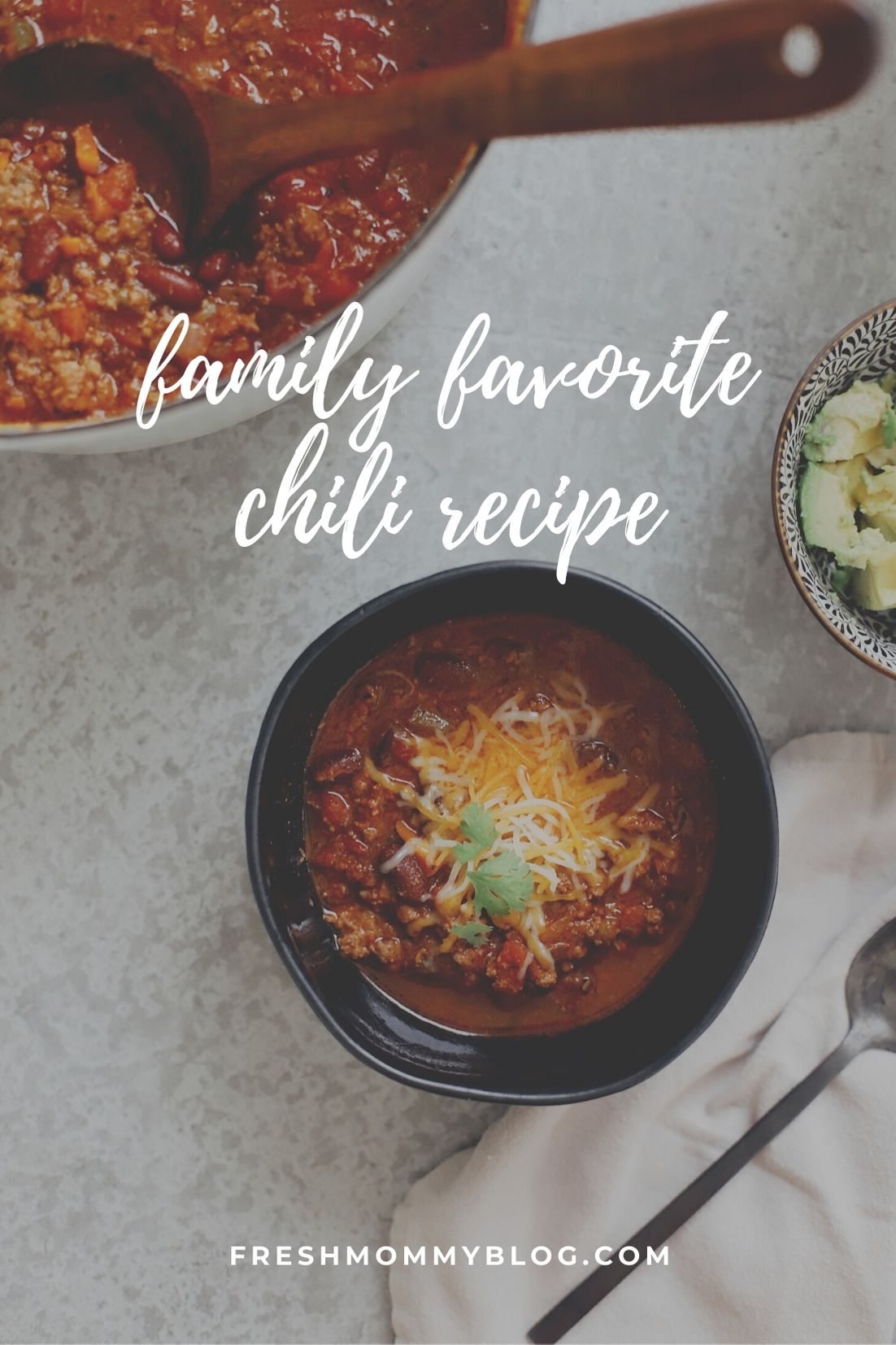 Easy Family Favorite Chili recipe! Make this delicious classic homemade chili in the crockpot or in one pot easily. It's THE BEST CHILI, and my family asks me to make it over and over. | Chili Recipe by popular Florida lifestyle blog, Fresh Mommy Blog: Pinterest image of chili in a black ceramic bowl with shredded cheese on top. 