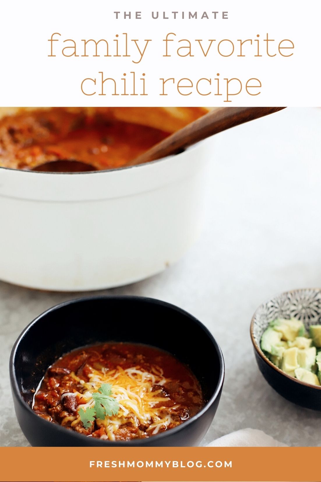 Easy Family Favorite Chili recipe! Make this delicious classic homemade chili in the crockpot or in one pot easily. It's THE BEST CHILI, and my family asks me to make it over and over. | Chili Recipe by popular Florida lifestyle blog, Fresh Mommy Blog: Pinterest of chili in a black ceramic bowl with shredded cheese on top. 