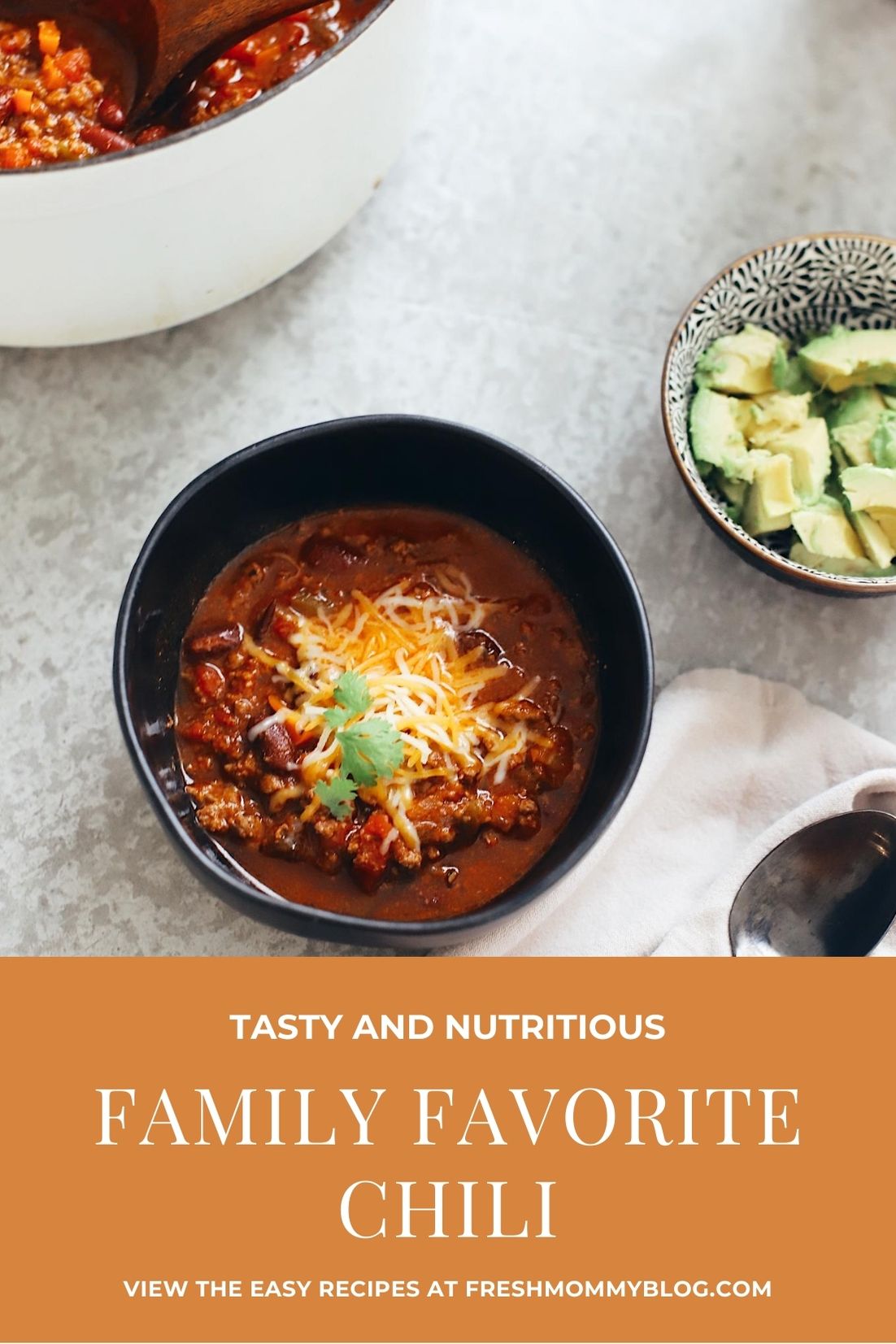 Easy Family Favorite Chili recipe! Make this delicious classic homemade chili in the crockpot or in one pot easily. It's THE BEST CHILI, and my family asks me to make it over and over. | Chili Recipe by popular Florida lifestyle blog, Fresh Mommy Blog: Pinterest image of chili in a black ceramic bowl with shredded cheese on top. 