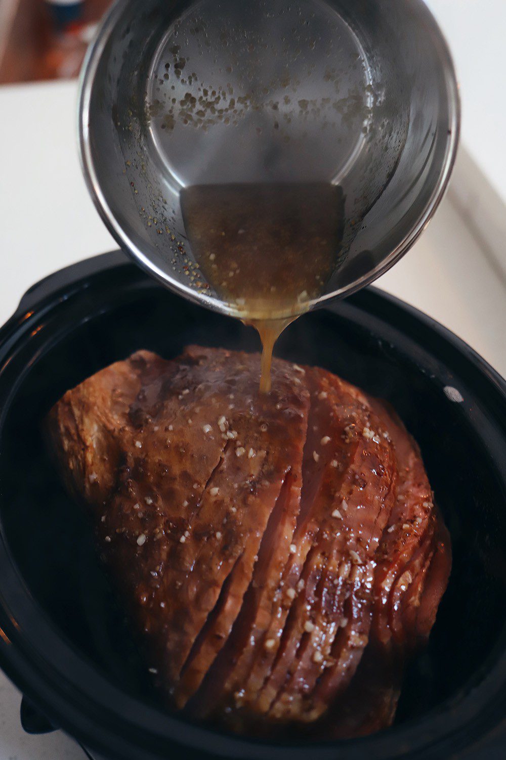 Delicious Spiced Glazed Ham for Easy Ham in the Slow Cooker With Pineapple. Great for Christmas dinner, holiday feasts, family dinner and more from lifestyle blogger Tabitha Blue of Fresh Mommy Blog.