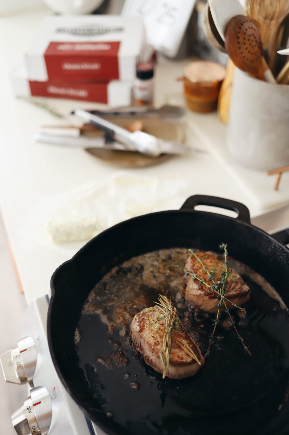 Homemade Steak Butter: How to Make an Easy Steakhouse Herb Butter for Steak |Steak Butter by popular Florida lifestyle blog, Fresh Mommy Blog: image of steak cooking in a skillet. 