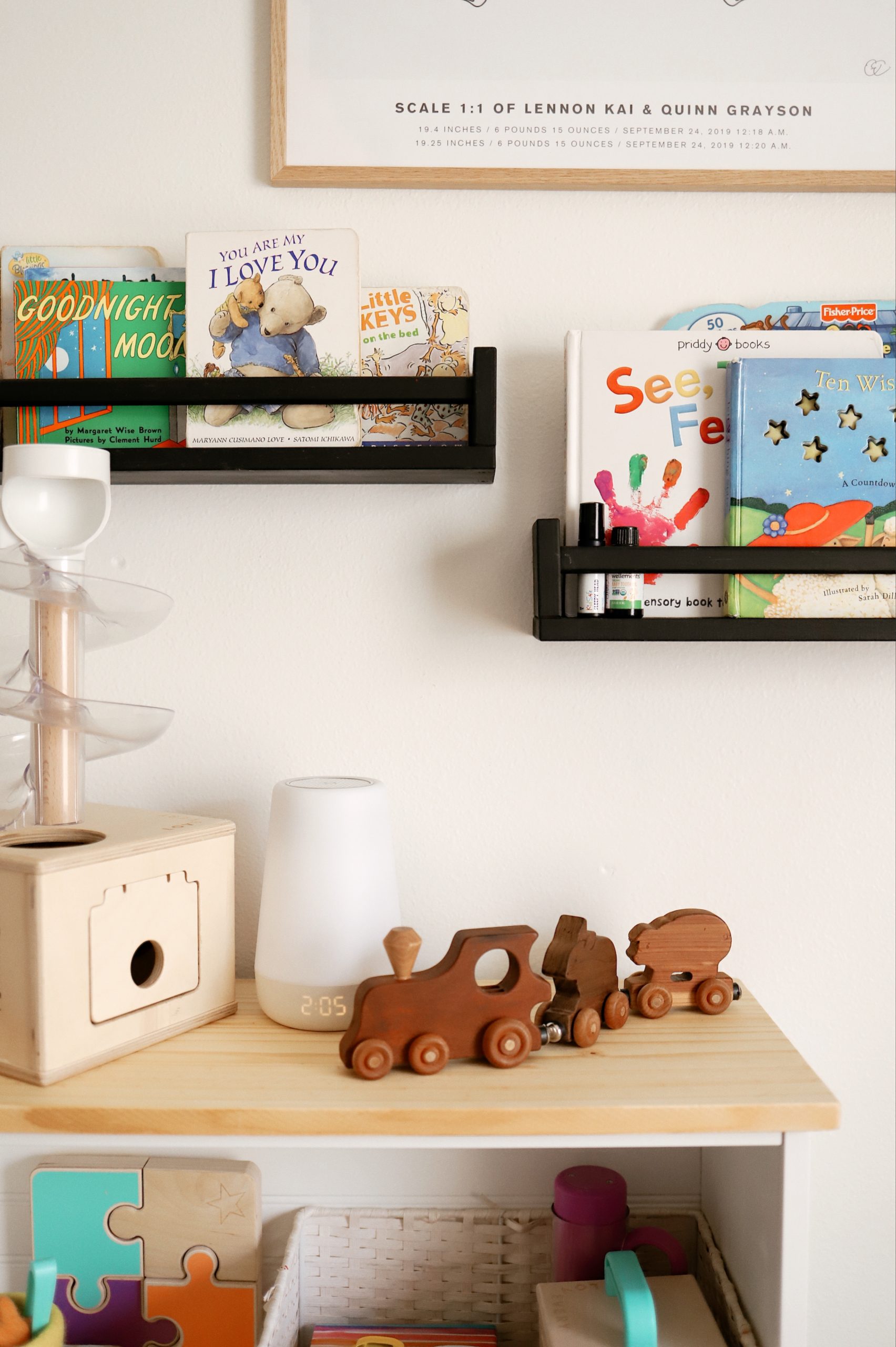 How to Upcycle your Cheap Bookcase into Stylish Mid Century Shelves: a Step by Step Tutorial featured by top FL DIY blogger, Tabitha Blue of Fresh Mommy Blog | Cheap Bookcase by poplar Florida DIY blog, Fresh Mommy Blog: image of a white bookcase filled with wooden baby toys. 