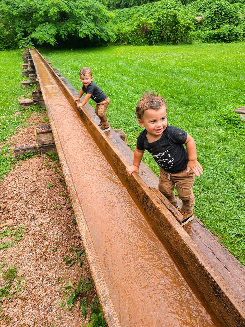 Best Things to Do in Bryson City NC with Kids - Try Gem Mining with the Family | Things to do in Bryson City NC by popular Florida travel blog, Fresh Mommy Blog: image of young twin boys mining for gems. 