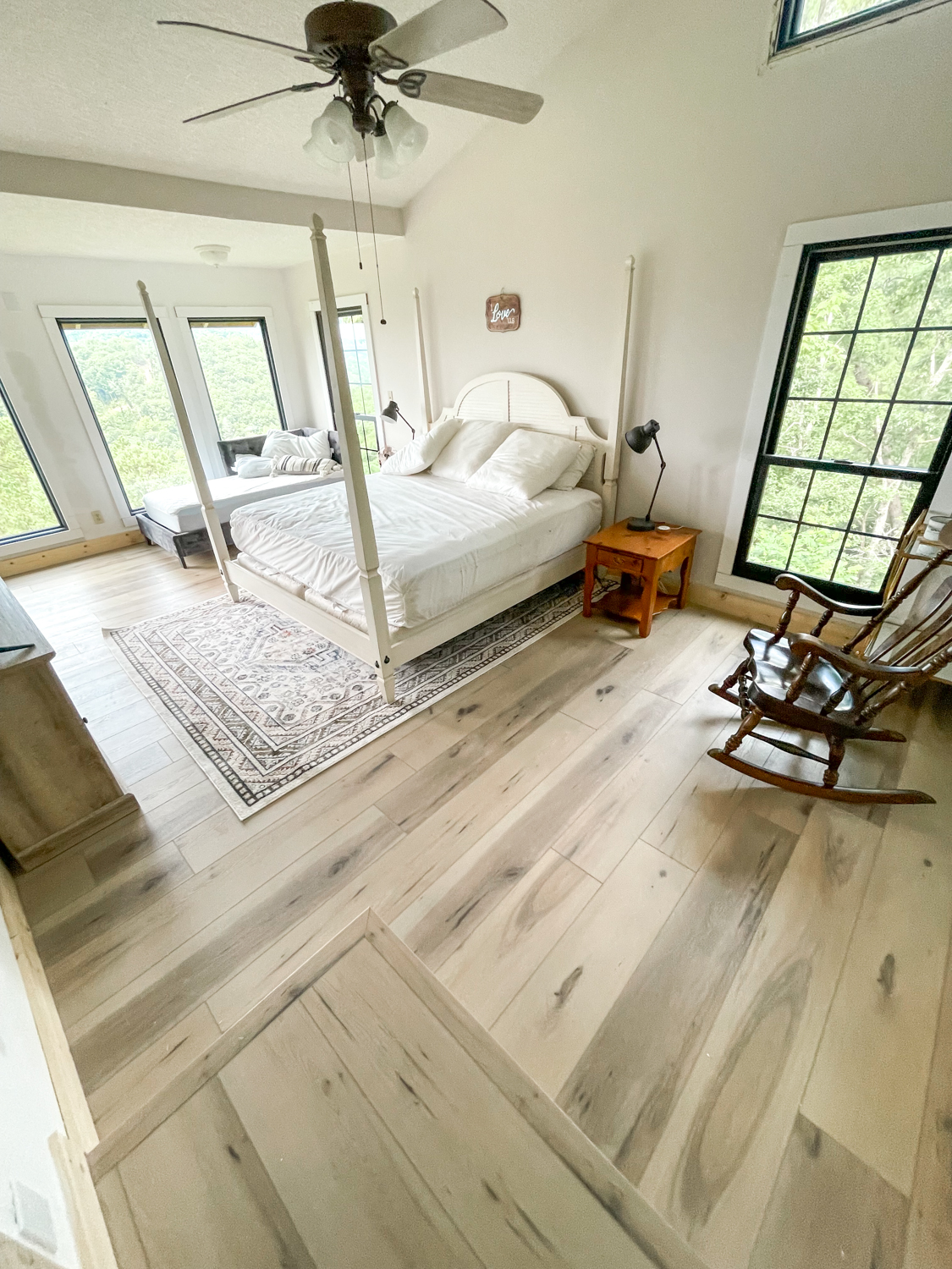 master bedroom after with new luxury vinyl plank flooring